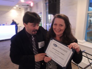 Garden City Life/Long Island Weekly editor Dave Gil de Rubio with old friend and current managing editor Edith Updike after she pulled down Third Place for Narrative: Business for the Syosset/Jericho Tribune.