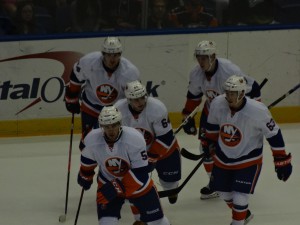 The white team skated back to their bench quickly to celebrate a goal. 