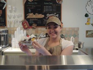 A Five Pennies Creamery employee with a finished banana split