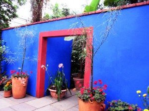The blue wall and red doorway replicate portions of La Casa Azul, Kahlo’s childhood home outside Mexico City