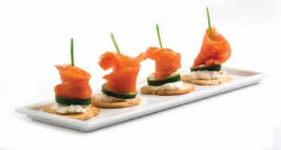 Four delicious smoked salmon in plate on white background.